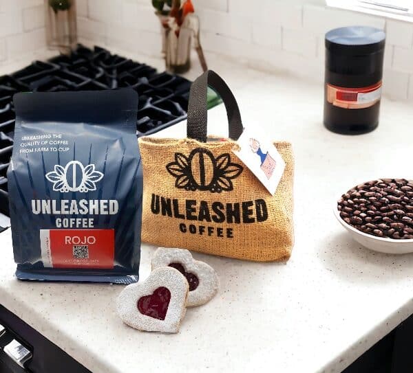 bag of whole beans on the counter with a burlap gift sac and some heart shaped cookies.